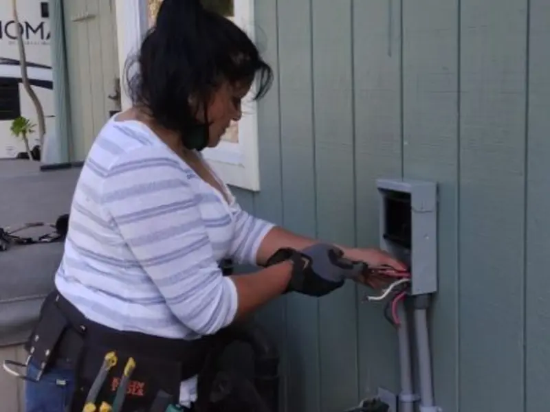 Licensed electrician wiring an exterior subpanel in Gautier